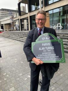 Dermot Turing with a plaque for the Parvis Alan Turing