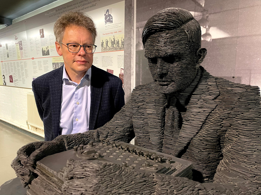 Dermot Turing with statue of Alan Turing at Bletchley Park. Photo by K T Bruce