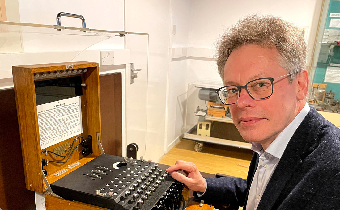 Dermot Turing with an Enigma machine. Photo by KT Bruce